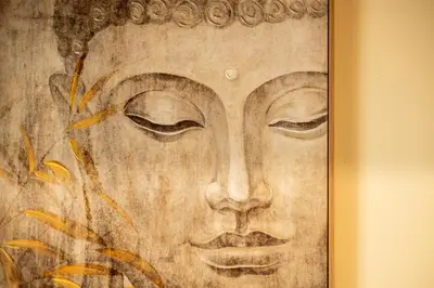 a painting of a face in a gold frame at The Botanist Rooms, Ritzou in Chania Town