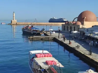 two boats docked at a dock with a cruise ship at Dk central apartment in the heart of the city in Chania Town