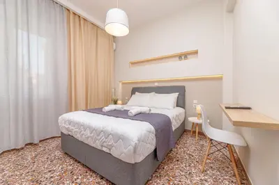 a bedroom with a bed and a desk and a desk at Dk central apartment in the heart of the city in Chania Town