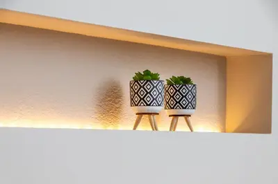 two plants in black and white vases on a shelf at Dk central apartment in the heart of the city in Chania Town