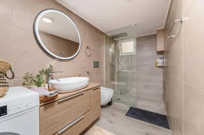 a bathroom with a sink and a mirror at Dk central apartment in the heart of the city in Chania Town