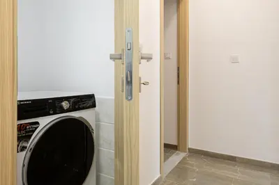 a washing machine in a room next to a door at Villa panagiotis in Kissamos