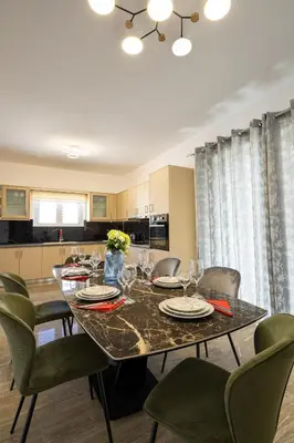 a dining room with a table and chairs and a kitchen at Villa panagiotis in Kissamos