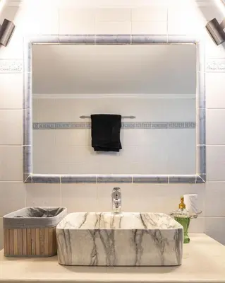 a bathroom with a marble sink and a mirror at Villa panagiotis in Kissamos
