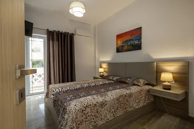 a bedroom with a bed and a large window at Villa panagiotis in Kissamos