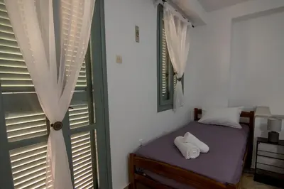 a bedroom with a bed with two white towels on it at Casa Bollani - Old Town Chania House in Chania Town