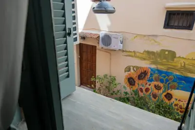 a door leading into a room with a mural at Casa Bollani - Old Town Chania House in Chania Town