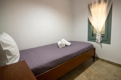 a bedroom with a bed with two towels on it at Casa Bollani - Old Town Chania House in Chania Town