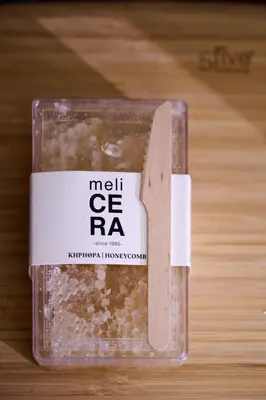 a plastic container ofmetrere rainoa on a wooden table at Elyn House in Chania Town