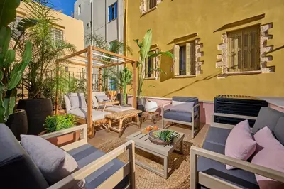 a patio with chairs and a gazebo at Elyn House in Chania Town
