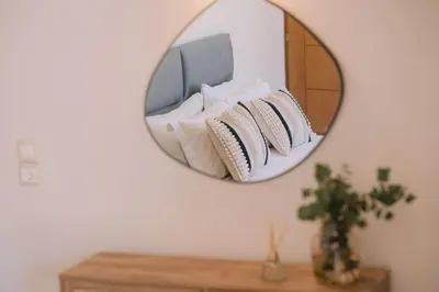 a mirror on a wall with pillows on a shelf at Summer Blue Apartments Chania in Chania Town