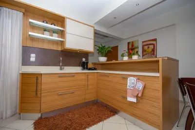 a kitchen with wooden cabinets and a sink at Jasmine House Kissamos in Kissamos