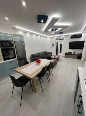 a living room with a table and chairs and a couch at CARA Creta Home in Kolymvari