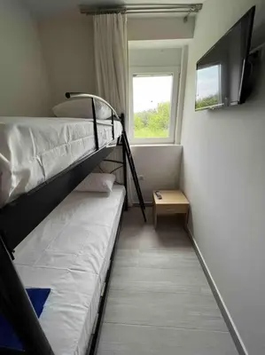 a bedroom with two bunk beds and a window at CARA Creta Home in Kolymvari