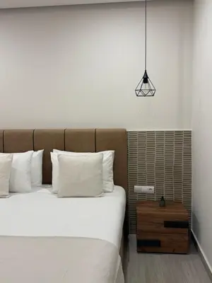 a bed with white sheets and pillows in a room at CARA Creta Home in Kolymvari