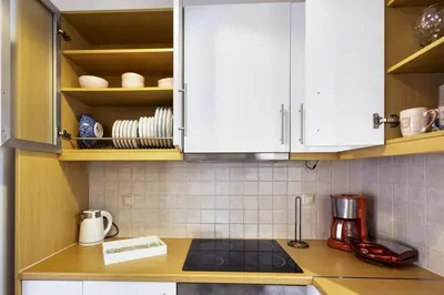 a kitchen with white cabinets and a counter top at Lazaretta apartment 2 in Chania Town