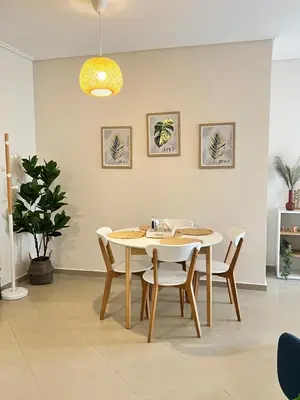 a dining room with a white table and chairs at Lazaretta apartment 2 in Chania Town
