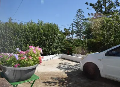 a white car parked next to a pot of flowers at Agrabeli Cot Not Just a Stay A Unique Experience in Plátanos