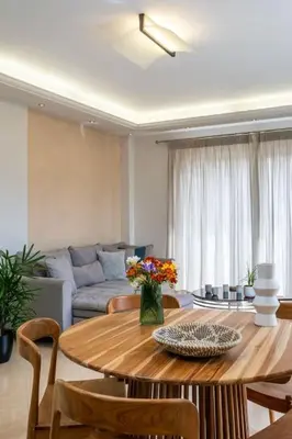 a living room with a table and a couch at Emma Hills Villa in Korakiaí