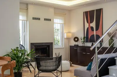 a living room with a fireplace and a couch at Emma Hills Villa in Korakiaí