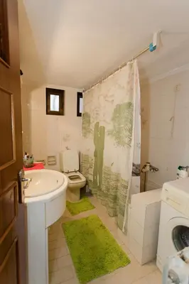 a bathroom with a sink and a toilet and a shower at Arias'-Welcoming Guest House in Kounoupidhianá