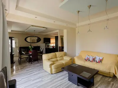 a living room with two couches and a table at Arias'-Welcoming Guest House in Kounoupidhianá