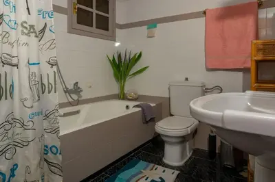 a bathroom with a toilet and a sink and a tub at Seize the seas in Kalamaki Chanion