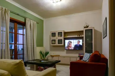 a living room with a couch and a tv at Seize the seas in Kalamaki Chanion