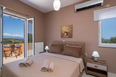 a bedroom with a bed with two towels on it at Olive Tree Villa in Chania Town