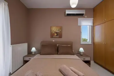 a bedroom with a bed with two towels on it at Olive Tree Villa in Chania Town