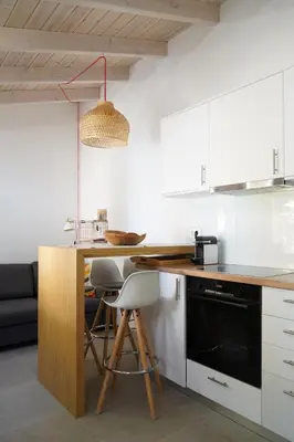 a kitchen with white cabinets and a wooden counter top at Lindas Convent Garden Home 2 in Chania Town