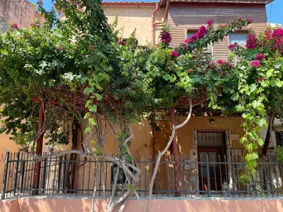a house with flowers on the side of it at Lindas Convent Garden Home 2 in Chania Town