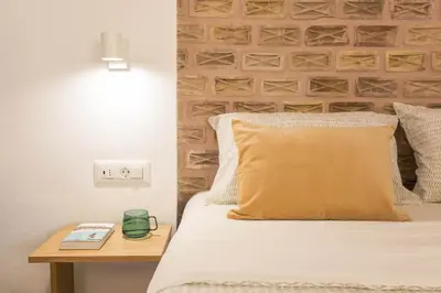a bedroom with a bed with a night stand next to a bed sidx sidx sidx at Lindas Convent Garden Home 2 in Chania Town