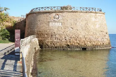 a brick wall in the water next to the ocean at Lindas Convent Garden Home 2 in Chania Town