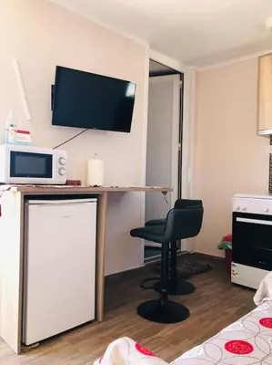 a room with a desk with a chair and a microwave at Ariadni's apartment 3 in Chania Town