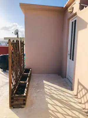 a porch of a house with a gate and a door at Ariadni's apartment 3 in Chania Town