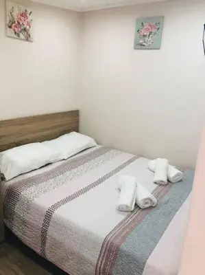 a bedroom with a bed with white towels on it at Ariadni's apartment 3 in Chania Town