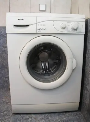 a white washing machine sitting in a room at Anna Kavros appartment in Chania Town