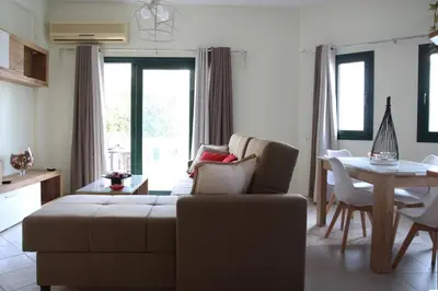 a living room with a couch and a table at Anna Kavros appartment in Chania Town