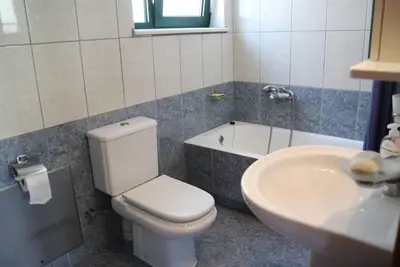 a bathroom with a toilet and a sink and a tub at Anna Kavros appartment in Chania Town
