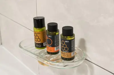 three bottles of essential oils sitting on a glass shelf at Villa Androniki in Souda