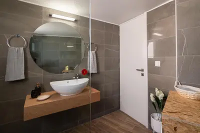 a bathroom with a sink and a mirror at Michail Suite Chania δίπλα στην παραλία της πόλης in Chania Town
