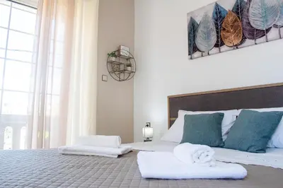 a bedroom with a large bed with towels on it at Eva's Residence, Family Apartment in Chania Town