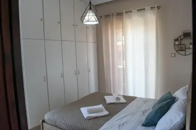 a bedroom with a bed with towels on it at Eva's Residence, Family Apartment in Chania Town