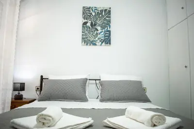 a bedroom with a bed with towels on it at Eva's Residence, Family Apartment in Chania Town