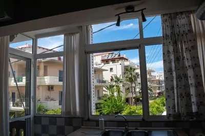 a kitchen window with a view of a city at Eva's Residence, Family Apartment in Chania Town