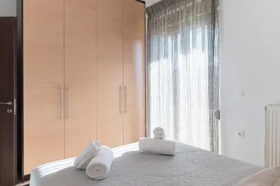 a bedroom with towels on a bed with a window at Dejaview cozy apartment by 8essentially in Chania Town