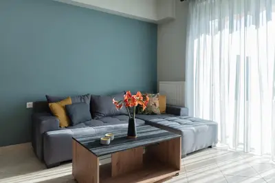 a living room with a couch and a table at Dejaview cozy apartment by 8essentially in Chania Town