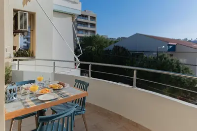 a balcony with a table with food on it at Dejaview cozy apartment by 8essentially in Chania Town