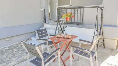 a table and chairs sitting on a patio at Lampros house in the countryside in Chania Town